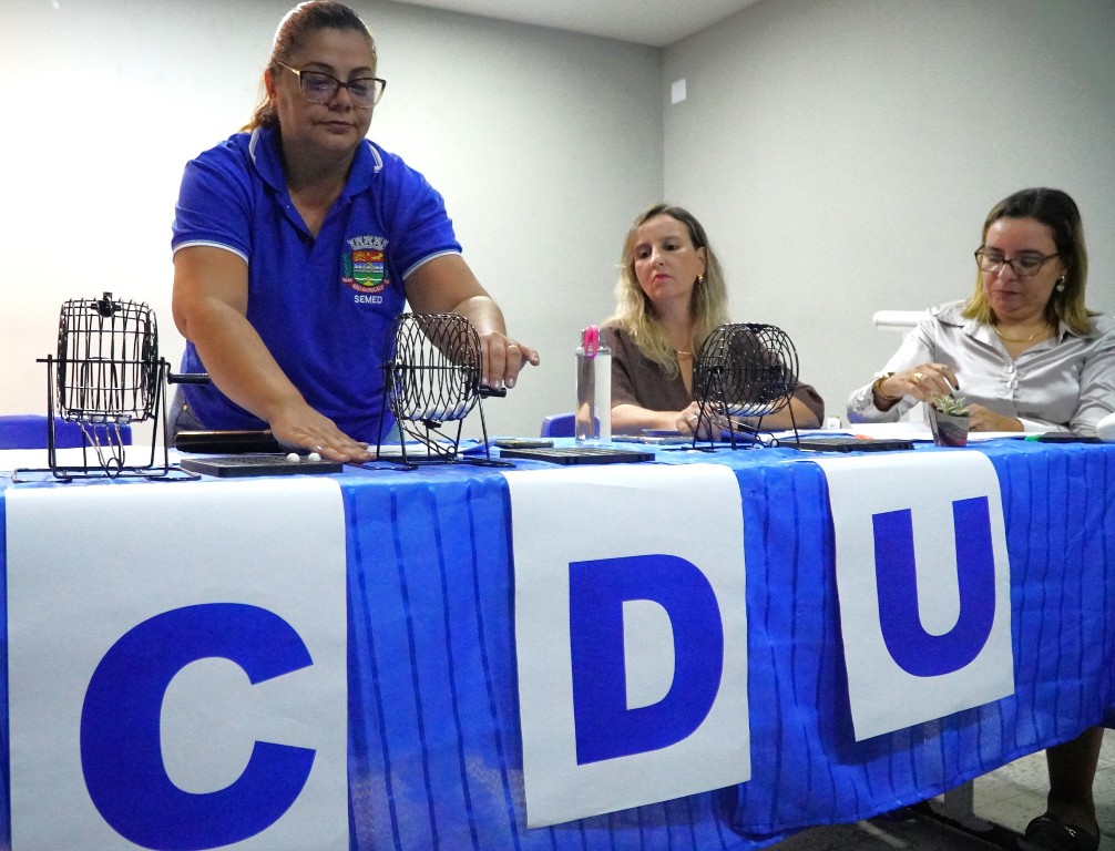 Pais e crianças em frente a um centro de autismo em São Gonçalo após sorteio de vagas.