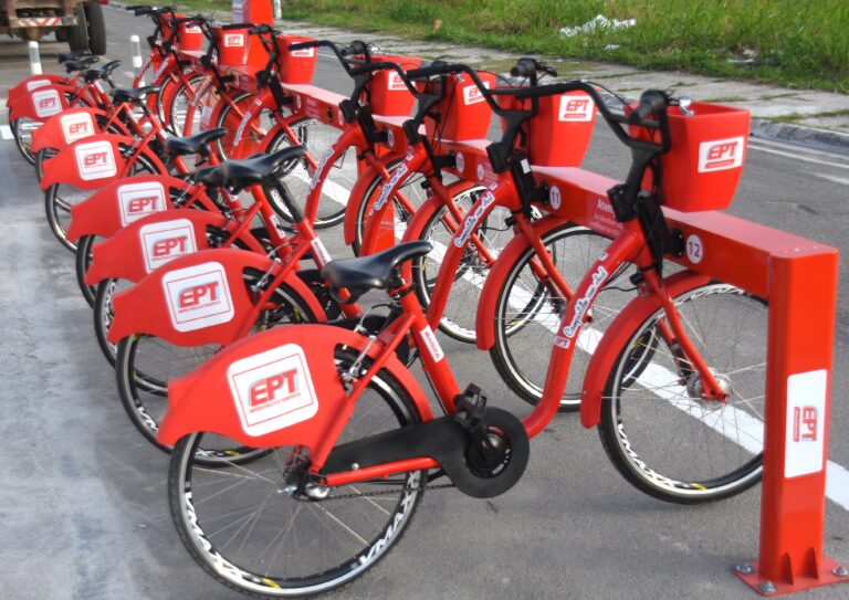 Usuário de bicicleta Vermelhinha em Maricá, sistema de compartilhamento gratuito.
