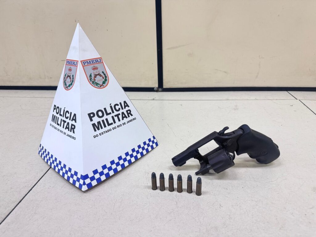Policiais militares em abordagem a um ônibus, com um homem detido e um revólver apreendido em Maricá.