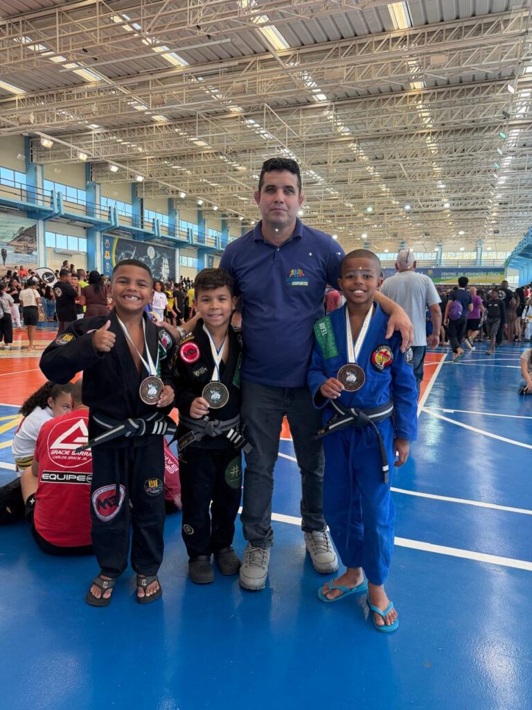 Jovens atletas de São Gonçalo do projeto São Gonçalo no Esporte exibem medalhas de Jiu-jítsu após competição da Marinha.