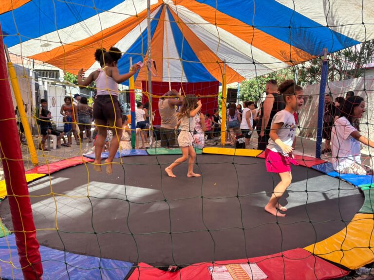 Crianças brincam em pula-pula e brinquedos infláveis em evento da Caravana de Arte e Lazer em São Gonçalo.