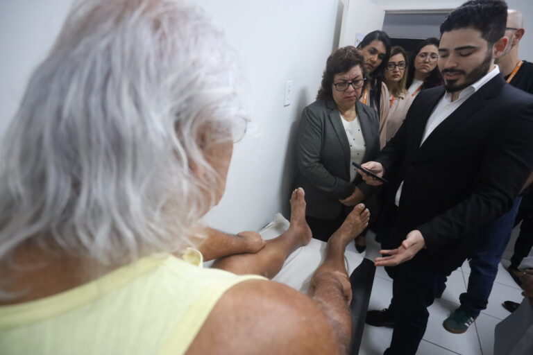 Profissional de saúde avalia pé de paciente com diabetes usando tecnologia de inteligência artificial em Niterói.