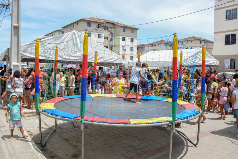 Crianças brincam em evento de Dia das Crianças em Maricá, com brinquedos infláveis e atividades.