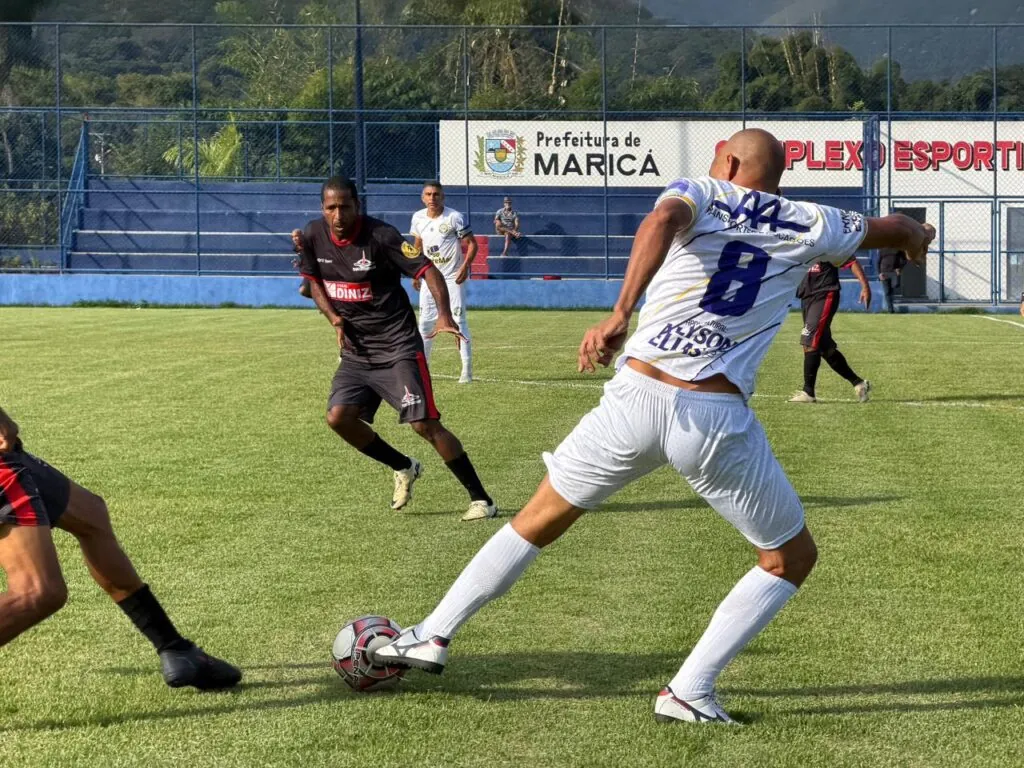 Jogadores de futebol amador em campo durante partida da Taça Cidade de Maricá em Maricá.