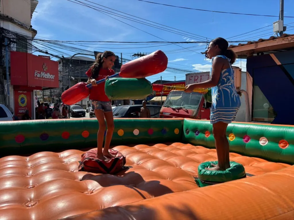 Crianças brincam em pula-pula e brinquedos infláveis na Caravana de Arte e Lazer em São Gonçalo.